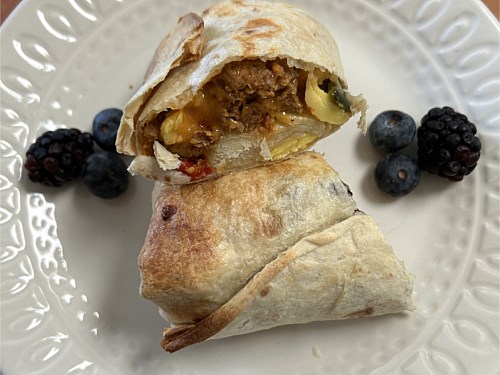 Scrambled egg and plant based ''sausage'' breakfast wrap ( Vegetarian )
